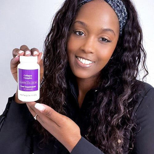 Woman smiling and holding a bottle of Hey Nutrition Collagen Complex food supplement with hyaluronic acid and sea kelp, 60 capsules.
