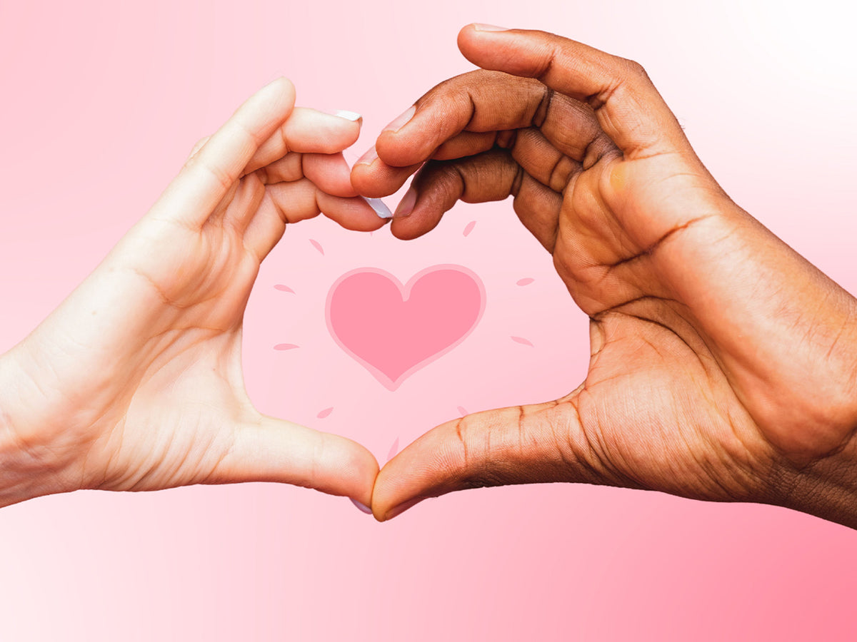 Two hands forming a heart shape against a pink background, representing thyroid and heart health connection.